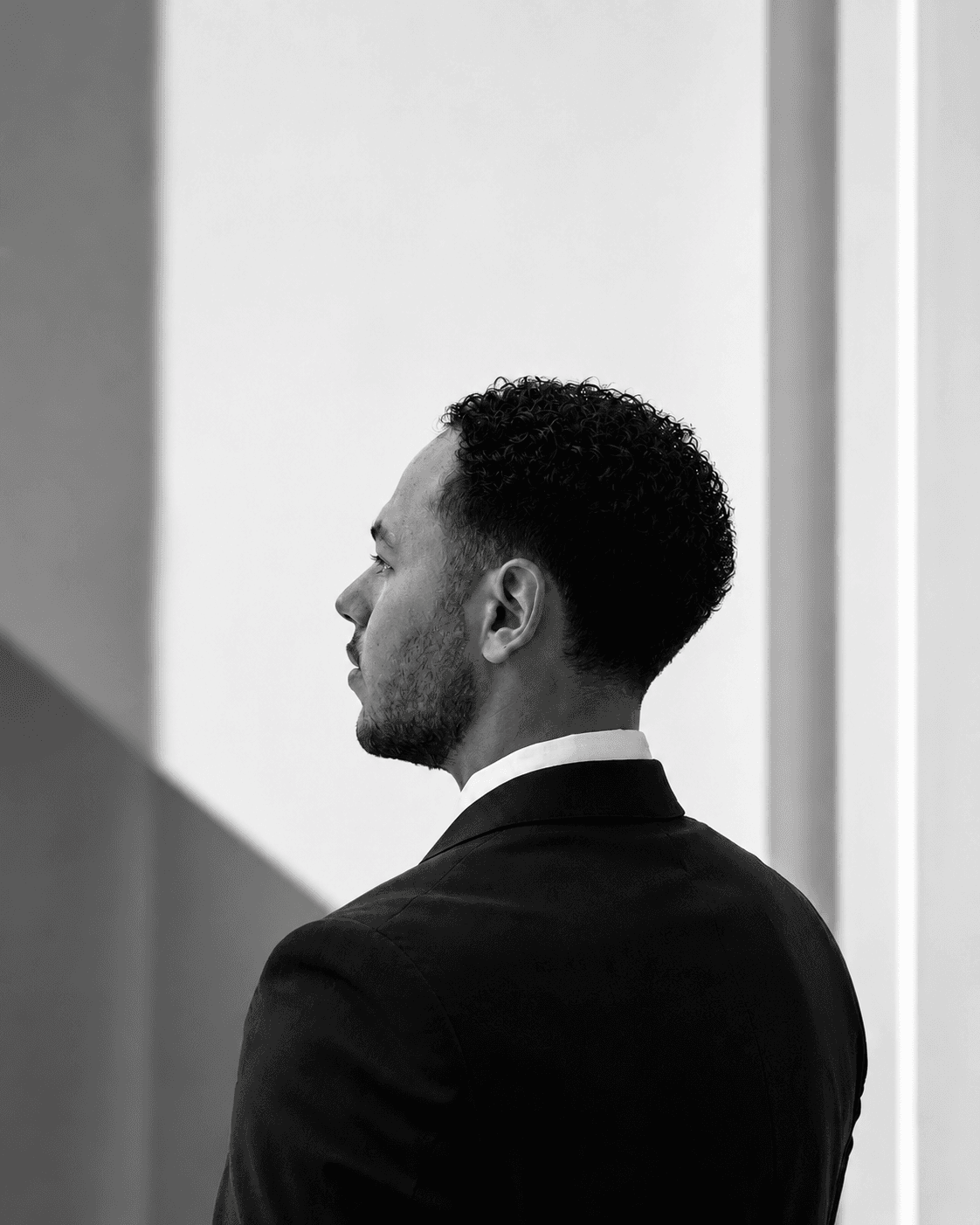 Black and white side-profile portrait of Ahmad Abughanam